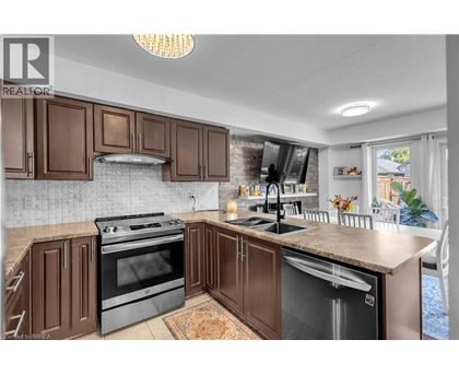 A kitchen with brown cabinets and a black stove top oven.