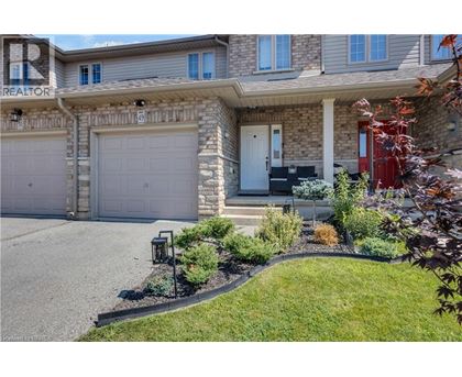 A house with a grey garage door and a red door.