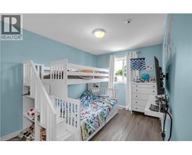 A bedroom with a bunk bed and a dresser.