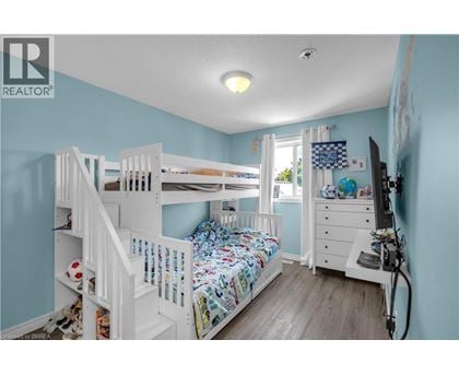 A bedroom with a bunk bed and a dresser.