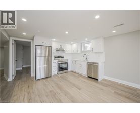 A modern kitchen with white cabinets and stainless steel appliances.
