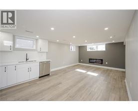 A spacious living room with a fireplace and hardwood flooring.