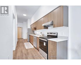 A modern kitchen with wooden cabinets and stainless steel appliances.