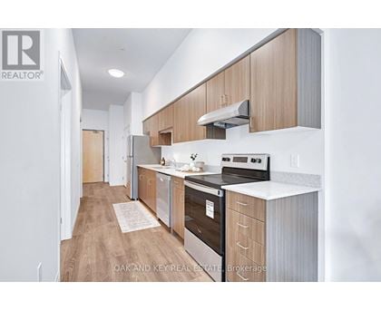 A modern kitchen with wooden cabinets and stainless steel appliances.