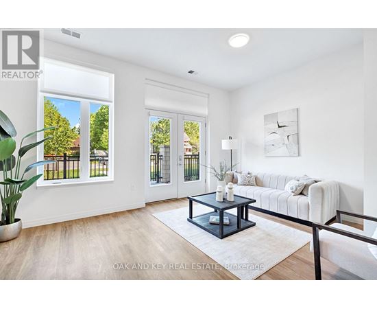 A living room with a white couch and a coffee table in the center.