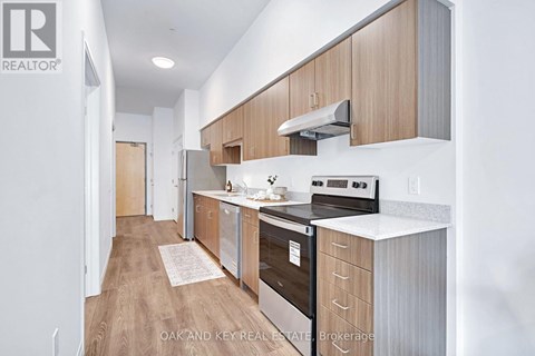 A modern kitchen with wooden cabinets and stainless steel appliances.