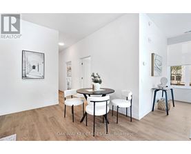 A dining room with a table set for four.