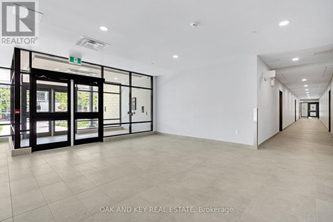 A spacious office with a glass door entrance and a tiled floor.