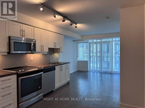 A kitchen with a stove top oven and microwave.