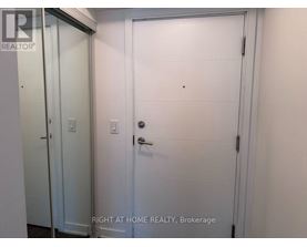 A white door with a handle and a small hole in the center of the door.