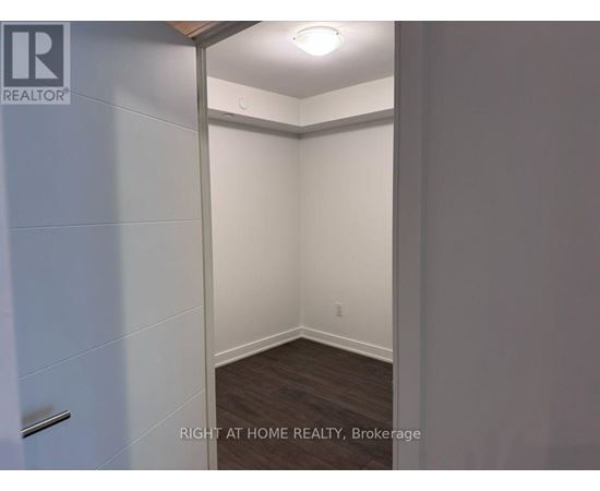 A brokerage image of an empty room with a white door.
