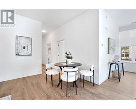 A dining room with a table set for four.