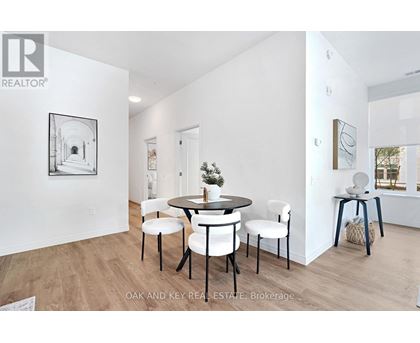 A dining room with a table set for four.