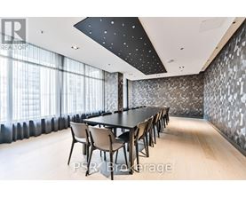 A conference room with a long table and chairs.