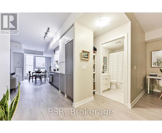 A well-lit, spacious kitchen and dining area with a breakfast bar.