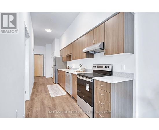 A modern kitchen with wooden cabinets and stainless steel appliances.