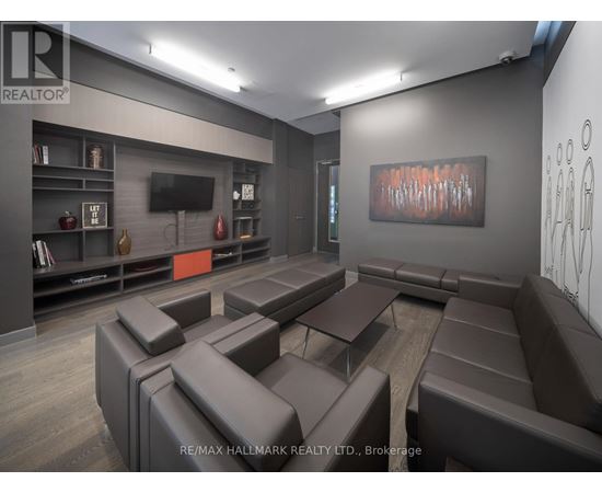 A modern living room with brown leather furniture and a flat screen TV.
