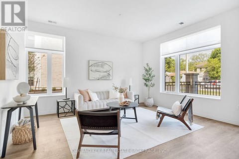 A living room with a white couch and a large window.