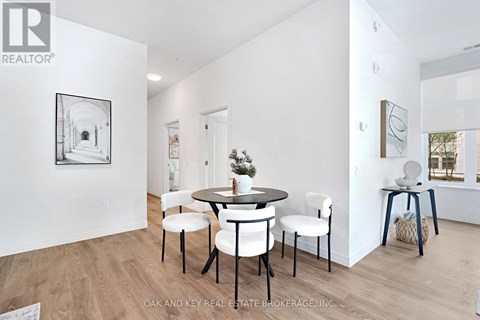 A dining room with a table and chairs.