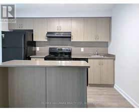 A kitchen with a black fridge, stove, and oven.