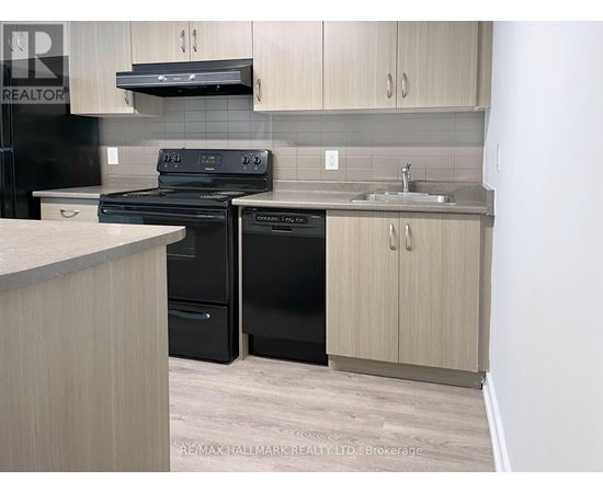 A kitchen with a black stove and black dishwasher.