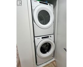A Whirlpool washing machine and dryer in a small laundry room.