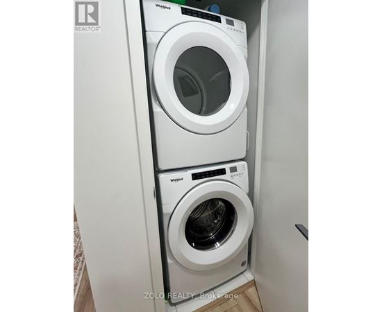 A Whirlpool washing machine and dryer in a small laundry room.