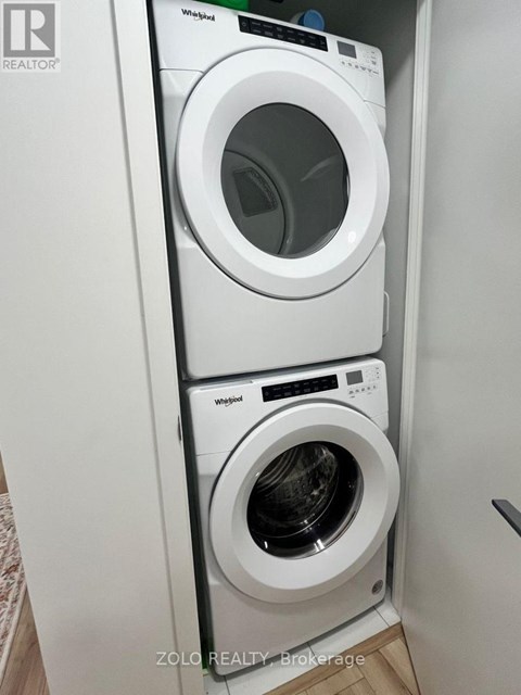 A Whirlpool washing machine and dryer in a small laundry room.