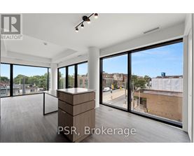 A large, empty room with a view of the street outside.