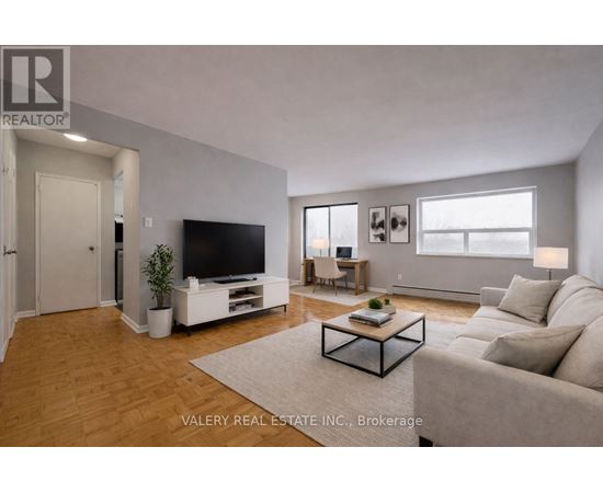 A living room with a television, couch, and coffee table.