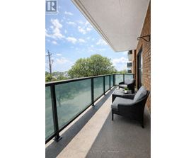 A balcony with a chair and a table with a plant on it.