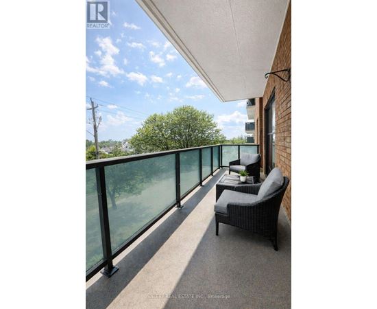 A balcony with a chair and a table with a plant on it.