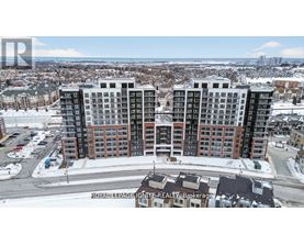 A large apartment complex is surrounded by a snowy landscape.