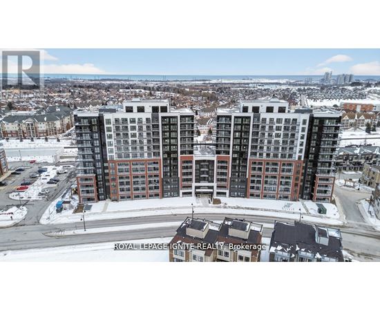 A large apartment complex is surrounded by a snowy landscape.