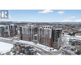 A real estate company logo is displayed on a snowy landscape with apartment buildings.