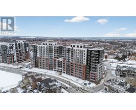 A real estate company logo is displayed on a snowy landscape with apartment buildings.