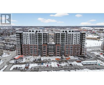 A large, multi-story building with a parking lot in front of it.