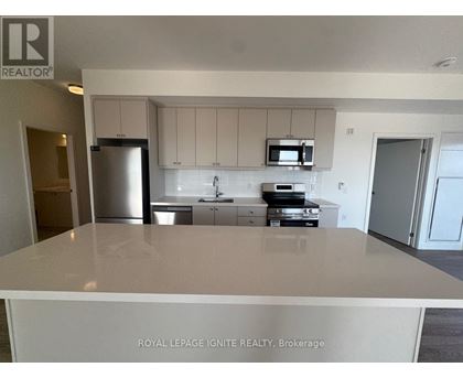 A kitchen with white cabinets and appliances is for sale.