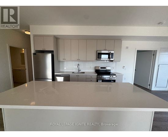A kitchen with white cabinets and appliances is for sale.