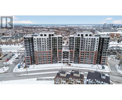 A large apartment complex is surrounded by a snowy landscape.