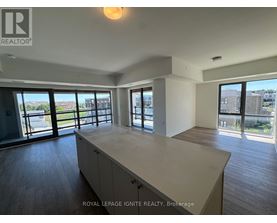 A spacious room with a large island in the middle and sliding glass doors.