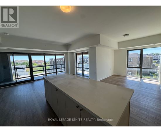 A spacious room with a large island in the middle and sliding glass doors.