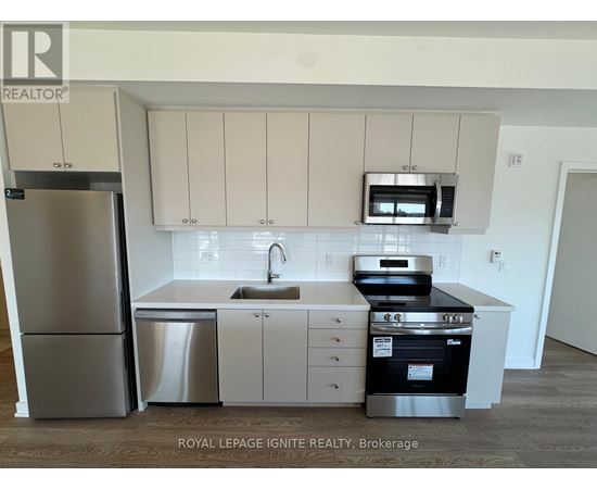 A kitchen with white cabinets and stainless steel appliances.