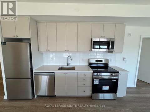 A kitchen with white cabinets and stainless steel appliances.