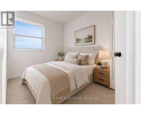 A bedroom with a bed, nightstand, and a painting on the wall.