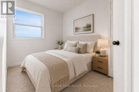 A bedroom with a bed, nightstand, and a painting on the wall.