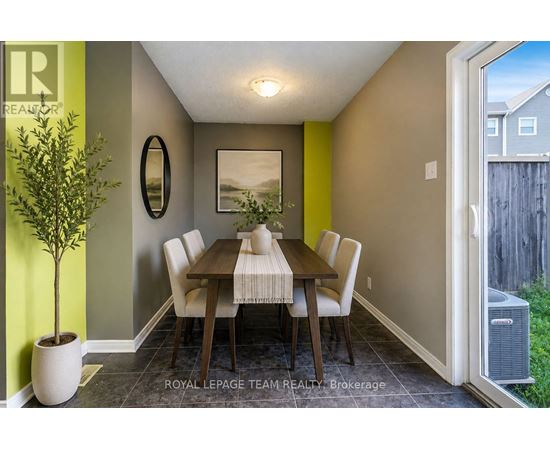 A dining room with a wooden table and chairs.