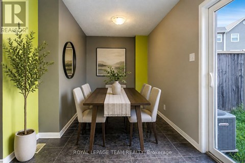 A dining room with a wooden table and chairs.