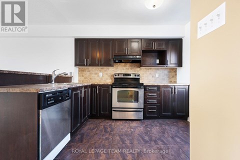 A kitchen with dark wood cabinets and stainless steel appliances.