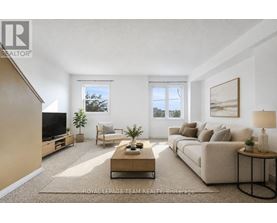 A well-lit living room with a beige sofa, a wooden coffee table, and a flat-screen TV.